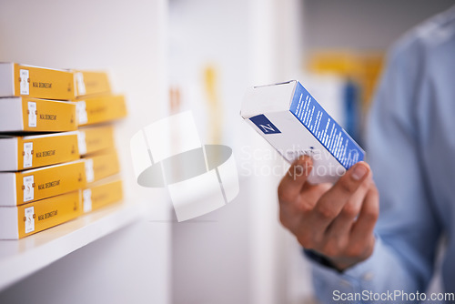 Image of Pharmacy, medicine and hands of man with pills reading label for medication, prescription and information. Healthcare, clinic and closeup of person with medical product, supplements and antibiotics