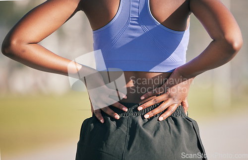 Image of Runner woman, back pain and outdoor with hands, emergency and problem with spine, muscle and training. Girl, running injury and accident with osteoporosis at workout, exercise or fitness in nature