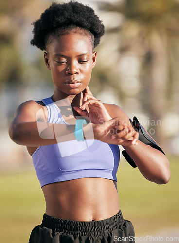 Image of Fitness, exercise and woman checking her pulse with smartwatch for running outdoor in nature. Sports, workout and African female athlete monitoring heart rate for cardio training for race or marathon