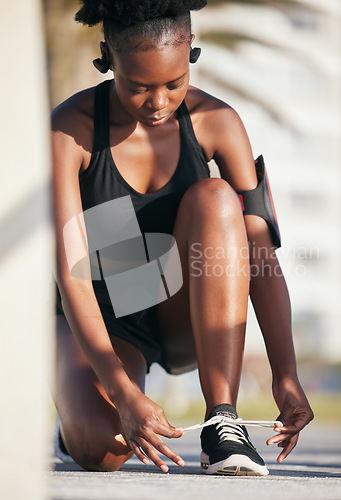 Image of Black woman, outdoor and tie shoes for workout, training and exercise. Sports, fitness and African athlete tying laces on sneakers to start running, prepare for cardio and jog, health and wellness