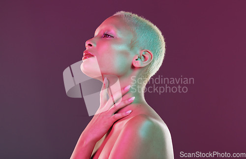 Image of Skincare, beauty and art, woman with neon makeup and lights for creative advertising on studio background. Cyberpunk, product placement and model isolated for skin care and futuristic mock up space.