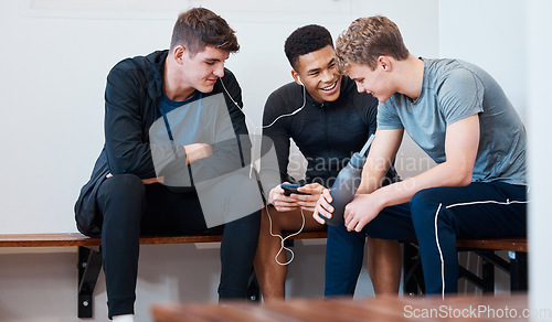 Image of Sports, locker room and friends with phone for music in gym for practice, exercise and training. Wellness, fitness club and men on smartphone listening to track, audio and radio to relax from workout