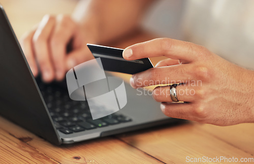 Image of Payment, credit card and hands with a laptop for online shopping, banking and finance. Ecommerce, retail and person typing debit information into a pc for a convenient electronic purchase on the web