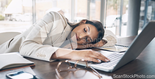 Image of Sleeping, laptop and business woman in office for exhausted, tired and overworked. Burnout, fatigue and lazy with employee napping at desk for stress, mental health and headache rest from pressure