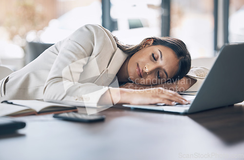 Image of Sleeping, tired and business woman at laptop in office for exhausted, dreaming and overworked. Burnout, fatigue and lazy with employee napping at desk for stress, mental health and headache rest