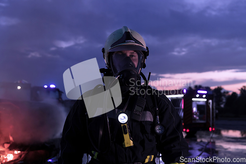 Image of Portrait of a heroic fireman in a protective suit. Firefighter in fire fighting operation.