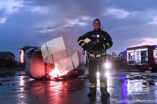 Image of Portrait of a heroic fireman in a protective suit. Firefighter in fire fighting operation.