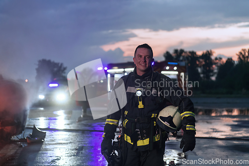 Image of Portrait of a heroic fireman in a protective suit. Firefighter in fire fighting operation.
