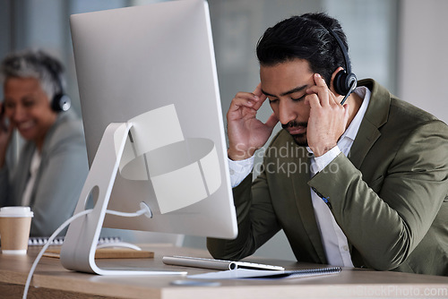 Image of Telemarketing, headache and man with stress, call center and burnout in office, overworked and fatigue. Male employee, consultant and agent for customer service, tech support and anxiety in workplace