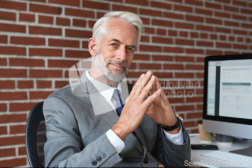 Image of Executive, senior and portrait of a businessman at a workspace with confidence and experience. Corporate, success and elderly ceo or manager working to success in an office while smiling for job