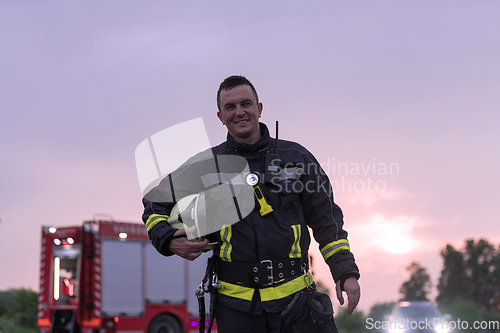 Image of Portrait of a heroic fireman in a protective suit. Firefighter in fire fighting operation.