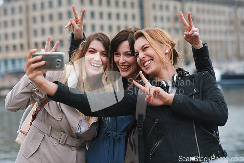 Image of Corporate women, selfie and peace in city with friends, profile picture and happy on travel. Young executive group, smartphone or solidarity for social media, blog and post by river in London metro