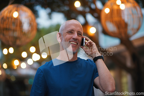 Image of Night, city and man on a phone call smile for networking, connection and chatting online in London. Communication, 5g smartphone and happy mature male in urban town talking, laugh and in conversation