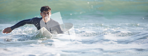 Image of Surfing, man and swimming in sea ocean of summer adventure, nature freedom or mockup banner. Happy young surfer guy, board and waves in water, beach and relax for holiday, sunshine travel or wellness