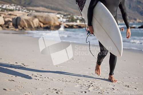 Image of Surfing, man and walking on sand, sea and ocean for summer vacation, freedom or wellness. Legs of surfer guy, board and walk on beach of relaxing holiday, travel adventure or water sports in sunshine