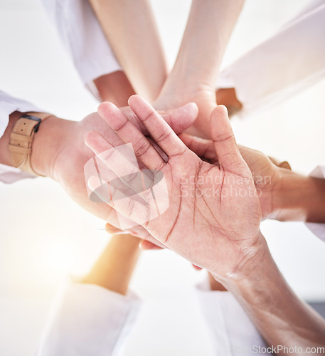 Image of Healthcare, teamwork and below hands of doctors for support, partnership and medicine trust. Motivation, success and medical workers in hand gesture for solidarity, mission and collaboration goals