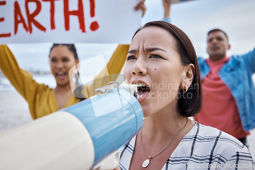 Image of Asian woman, climate change and megaphone protest with crowd protesting for environment and global warming. Save the earth, activism and angry female shouting on bullhorn to stop beach pollution.