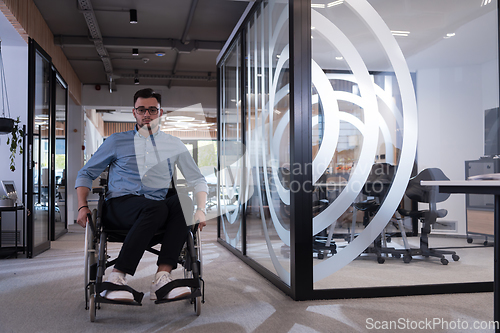 Image of In a large modern corporation, a determined businessman in a wheelchair navigates through a hallway, embodying empowerment and inclusivity in the corporate world.
