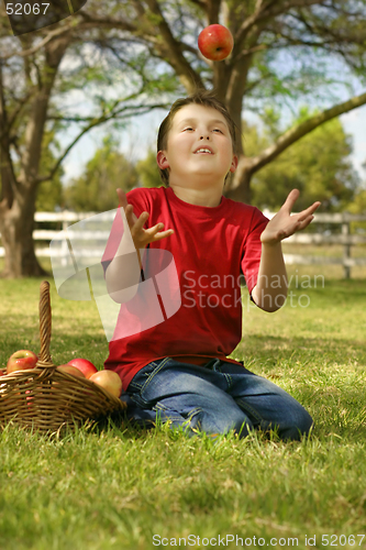 Image of Child throwing up an apple