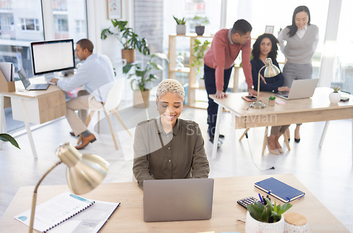 Image of Office, startup and black woman typing on laptop in coworking, workspace management and workflow planning. People, employees or business staff working together and teamwork for online career strategy