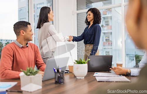 Image of Meeting, black woman or Asian manager shaking hands in startup business project deal in a digital agency. Teamwork, handshake or worker talking or speaking of our vision or b2b partnership agreement