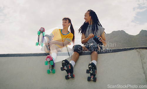 Image of Rollerskate, skatepark and fun with a couple of friends sitting outdoor on a ramp for recreation together. Fitness, diversity or sports with a man and woman bonding outside for an active hobby