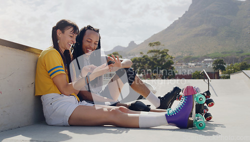 Image of Friends, phone and women relax after roller skate training in a skate park browsing social media trend on the internet. Online, connected and extreme sports people resting and laughing at meme