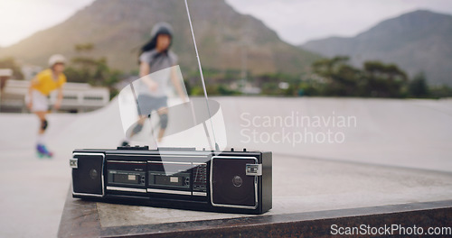 Image of Skate park, music and a retro radio outdoor for urban skating with people in blurred background. Freedom, cassette tape and energy for balance sports, action and training for fitness with audio sound