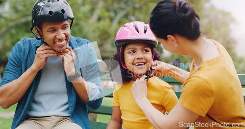 Image of Parents, park bench and helmet with child, help and safety for skating, rollerskate or bike. Interracial parents, mom and dad with helping hand, teaching and kid for bonding, learning and exercise