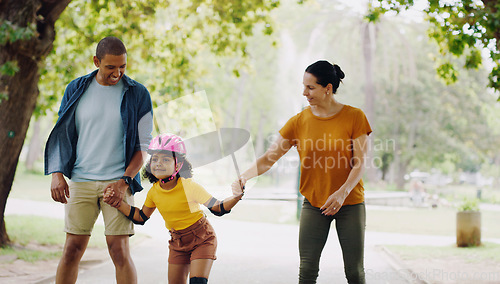 Image of Parents, park and holding hands to rollerskate with girl child with care, learning and support. Interracial family, black man and woman with kid, smile and helping hand for skating on outdoor holiday
