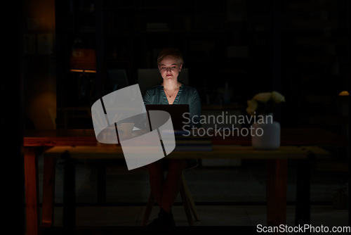 Image of Night, laptop and serious with woman in office for planning, overtime and corporate mockup. Deadline, technology and email with employee typing proposal at desk for business, trading and internet