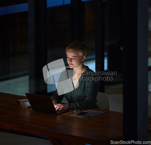 Image of Night, laptop and typing with woman in office for planning, overtime and corporate strategy. Deadline, technology and email with employee at desk for business proposal, online trading and internet