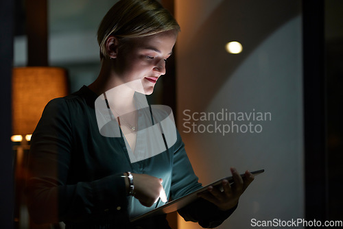 Image of Late, night and woman typing on tablet in the evening in a modern office, workplace and startup company. Person, workaholic and female entrepreneur typing on laptop in the dark due to power cut