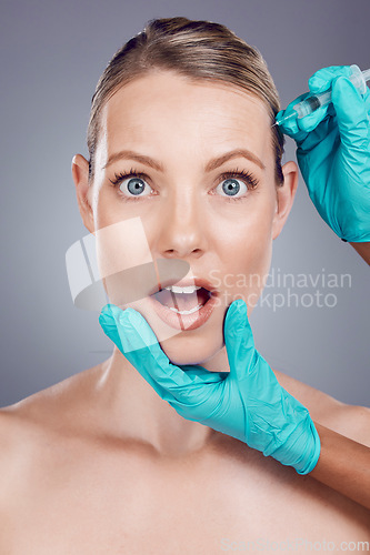 Image of Injection, scared woman and face for skincare, collagen and beauty process in studio. Cosmetics, surprise portrait and needle for plastic surgery, botox facial change and aesthetic prp on background