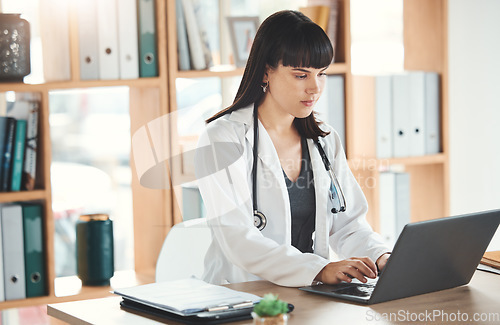 Image of Doctor, laptop and woman typing in hospital for research, online consultation or telehealth. Technology clinic, computer and female physician writing medical report, healthcare email or wellness app.