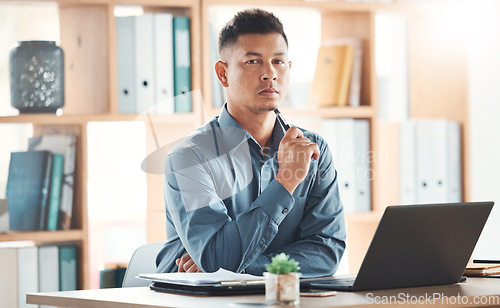 Image of Business, portrait and man in office, serious and assertive for deal, laptop and online planning for deadline. Face, male employee and consultant with device, assertive expression and leadership