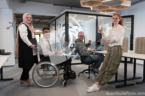 Image of Young group of business people brainstorming together in a startup space, discussing business projects, investments, and solving challenges.