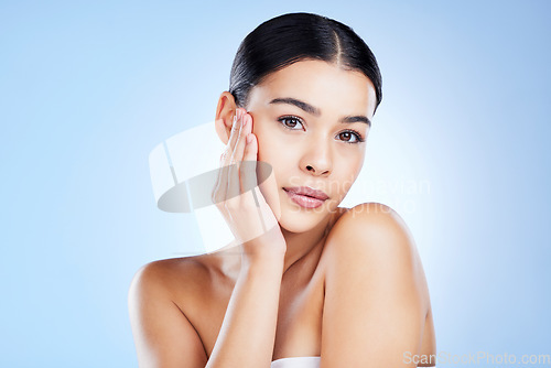 Image of Portrait, face and aesthetic with a model black woman in studio on a blue background for skincare. Relax, beauty and spa with an attractive young female posing to promote natural skin treatment