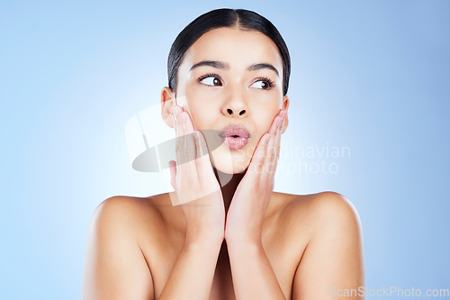 Image of Woman, beauty and skincare with pout, lips botox and aesthetic cosmetics on blue background. Female model, lip filler and kissing face for plastic surgery, facial treatment and dermatology in studio