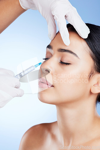 Image of Plastic surgery, surgeon hands and woman for beauty, filler injection and change in studio. Aesthetic model person and doctor for cosmetic surgery, face transformation or dermatology blue background
