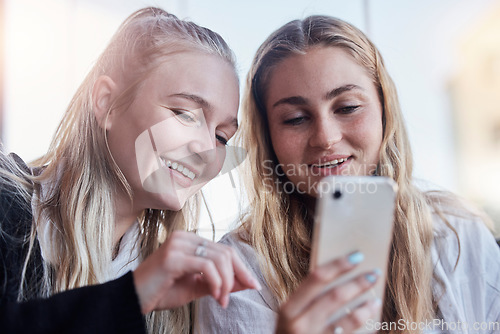 Image of Phone, social media and friends laughing at trending meme on the internet, web or website together outdoors in a city. People, app and women scrolling online sharing or streaming a video