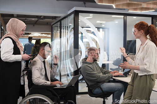 Image of Young group of business people brainstorming together in a startup space, discussing business projects, investments, and solving challenges.