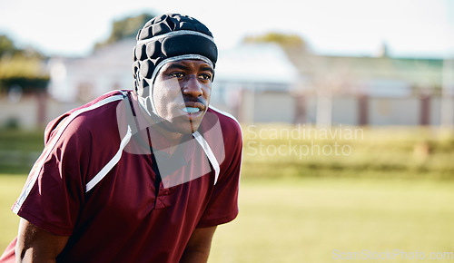 Image of Sports, rugby and black man athlete on field playing or training for a game or competition. Fitness, outdoor and African male football player doing exercise or workout on grass by a stadium or arena.