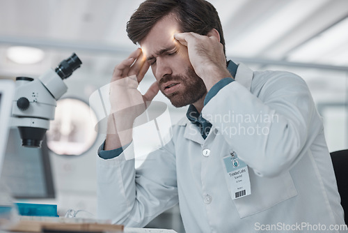 Image of Stress, man or scientist with headache in a laboratory suffering from burnout, migraine pain or overworked. Exhausted, frustrated or tired doctor working on medical science research with fatigue