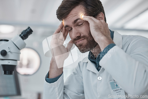 Image of Stress, doctor or scientist with headache in a laboratory suffering from burnout, migraine pain or overworked. Exhausted, frustrated or tired man working on science research with fatigue or tension