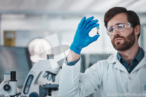 Image of Science, blood and dna with a doctor man at work in a laboratory for analysis or research. Medical, innovation and sample with a male scientist working in a lab for development or breakthrough