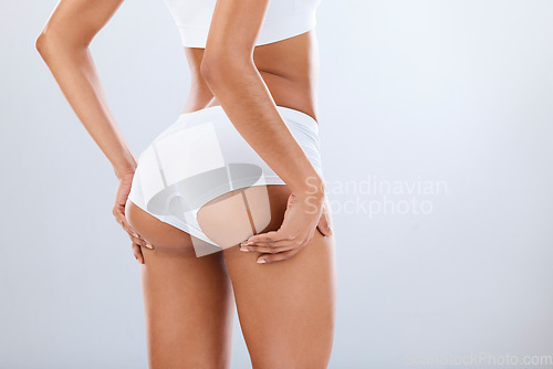 Image of Woman, butt and white underwear in studio, dermatology spa or cellulite skincare of body wellness. Female beauty model, sexy girl and lingerie of liposuction, healthy cosmetology or mockup background