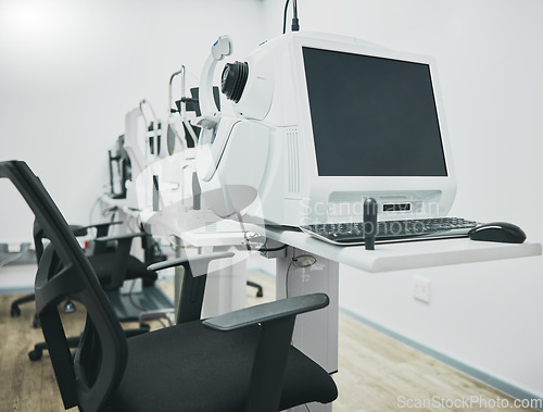 Image of Ophthalmology machine, eye test and interior with computer for healthcare, wellness and vision in office. Optometrist consultation room, pc and furniture with digital equipment by blurred background