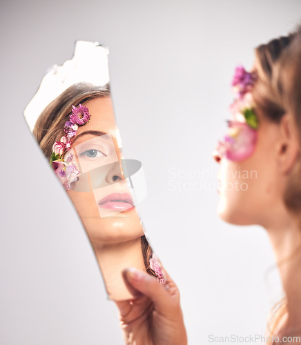 Image of Beauty, reflection and portrait of a woman with a broken mirror for an insecurity and problem. Mental health, makeup and face of a girl getting ready and looking at face isolated on a background
