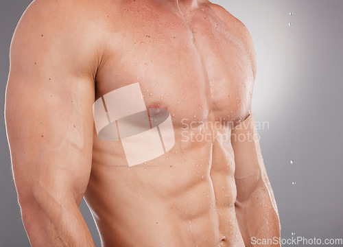 Image of Fitness, body muscle and water or sweat on a man for sport, exercise and training with mockup. Stomach abs, strong arms and model bodybuilder with isolated gray background in studio after workout